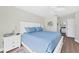 Bright main bedroom with king-size bed and ensuite bathroom access at 545 Foxwood Blvd # 23, Englewood, FL 34223