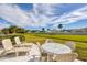 Outdoor patio area with seating and a view of a lush green lawn at 545 Foxwood Blvd # 23, Englewood, FL 34223