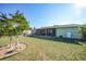 Spacious backyard with green lawn and view of the enclosed patio at 6543 Coliseum Blvd, Port Charlotte, FL 33981