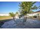 Outdoor patio featuring a glass-top table with seating for 4 and landscaped lawn at 6543 Coliseum Blvd, Port Charlotte, FL 33981