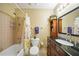 Cozy bathroom with a shower-tub combo, dark wood vanity and decorative floral accents at 6543 Coliseum Blvd, Port Charlotte, FL 33981