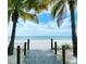 Scenic wooden path through palm trees leading to a beautiful white sand beach and the ocean at 6543 Coliseum Blvd, Port Charlotte, FL 33981