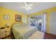 This bedroom features a ceiling fan, closet, and a view of the enclosed lanai at 6543 Coliseum Blvd, Port Charlotte, FL 33981