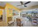 Bright dining area featuring a decorative table, open layout to the kitchen, and a view of the screened patio at 6543 Coliseum Blvd, Port Charlotte, FL 33981