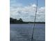 Fishing pole by the water, creating a sense of tranquility and outdoor recreation at 6543 Coliseum Blvd, Port Charlotte, FL 33981