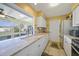 Bright kitchen featuring white cabinets, granite countertops, and a window overlooking the patio at 6543 Coliseum Blvd, Port Charlotte, FL 33981