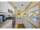 Bright kitchen featuring stainless steel appliances, light countertops, and an open view to the dining area at 6543 Coliseum Blvd, Port Charlotte, FL 33981