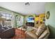 Inviting living room with decorative hutch, tile floors, wood floor accents, and large window at 6543 Coliseum Blvd, Port Charlotte, FL 33981