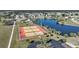 Aerial image of community tennis courts beside a pretty lake at 6543 Coliseum Blvd, Port Charlotte, FL 33981