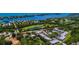 Aerial view showcasing golf course, water access, tennis courts, and community pool at 6800 Placida Rd # 122, Englewood, FL 34224