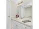 Well-lit bathroom featuring a sink with vanity, a decorative mirror, and neutral colors at 6800 Placida Rd # 122, Englewood, FL 34224