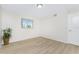 Bright bedroom features wood floors, fresh paint, and a sunny window at 6800 Placida Rd # 122, Englewood, FL 34224