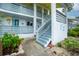 Exterior view of a well-maintained condo building with manicured landscaping and stairs at 6800 Placida Rd # 122, Englewood, FL 34224