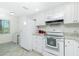 Clean, efficient kitchen with white appliances and plenty of counter space at 6800 Placida Rd # 122, Englewood, FL 34224