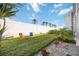 Private backyard with lawn, plants, and seating at 708 Tamiami S Trl # 103, Venice, FL 34285