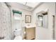 Bathroom with shower, toilet and vanity with wood grain cabinets at 708 Tamiami S Trl # 103, Venice, FL 34285