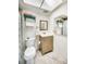 Bathroom with shower, toilet and vanity with wood grain cabinets at 708 Tamiami S Trl # 103, Venice, FL 34285