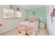 Bright bedroom with a queen bed and light decor at 708 Tamiami S Trl # 103, Venice, FL 34285