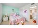 Bedroom with light teal walls, a queen bed, and adjacent bathroom at 708 Tamiami S Trl # 103, Venice, FL 34285