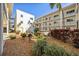 Relaxing courtyard with seating area and tropical landscaping at 708 Tamiami S Trl # 103, Venice, FL 34285