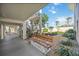 Building walkway with a bench and green landscaping at 708 Tamiami S Trl # 103, Venice, FL 34285