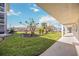 Walkway with green landscaping, offering a relaxing view at 708 Tamiami S Trl # 103, Venice, FL 34285