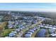 Community of mobile homes with pond and road at 717 Tangerine Woods Blvd, Englewood, FL 34223