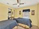 Guest bedroom with two twin beds and mirrored closet at 717 Tangerine Woods Blvd, Englewood, FL 34223