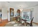 Dining room with glass table, wooden hutch, and chandelier at 717 Tangerine Woods Blvd, Englewood, FL 34223