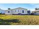 Exterior view of the house with green lawn at 717 Tangerine Woods Blvd, Englewood, FL 34223