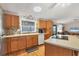 Kitchen features oak cabinets, stainless steel appliances, and a tile backsplash at 717 Tangerine Woods Blvd, Englewood, FL 34223