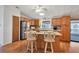 Bright kitchen with oak cabinets, stainless steel appliances, and an island at 717 Tangerine Woods Blvd, Englewood, FL 34223