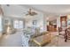 Open living room and dining area with ceiling fans at 717 Tangerine Woods Blvd, Englewood, FL 34223