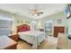 Spacious bedroom with a ceiling fan and wood furniture at 717 Tangerine Woods Blvd, Englewood, FL 34223