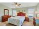 Main bedroom with a ceiling fan and ensuite dresser at 717 Tangerine Woods Blvd, Englewood, FL 34223