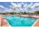 Community pool with plenty of lounge chairs at 717 Tangerine Woods Blvd, Englewood, FL 34223