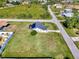 Aerial view of a single-Gathering home with a large backyard and solar panels at 7179 Lighthouse St, Englewood, FL 34224