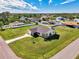 Aerial view of a single-Gathering home with a large backyard and solar panels at 7179 Lighthouse St, Englewood, FL 34224