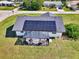 Aerial view of a home with solar panels and a screened patio at 7179 Lighthouse St, Englewood, FL 34224