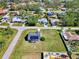 Aerial view of a single-Gathering home with solar panels and a large backyard at 7179 Lighthouse St, Englewood, FL 34224