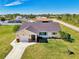 Single-story house with a gray roof, driveway, and a spacious backyard at 7179 Lighthouse St, Englewood, FL 34224