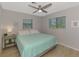 King size bedroom with ceiling fan and light wood floors at 7179 Lighthouse St, Englewood, FL 34224