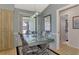 Dining area with glass-top table, chairs, and access to a screened lanai at 7179 Lighthouse St, Englewood, FL 34224