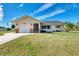 Single-story home with a white exterior, attached garage, and well-maintained lawn at 7179 Lighthouse St, Englewood, FL 34224