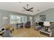 Bright living room featuring hardwood floors, comfortable seating, and large windows at 7179 Lighthouse St, Englewood, FL 34224