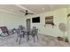 Covered patio with seating, dining area and mounted TV at 7179 Lighthouse St, Englewood, FL 34224