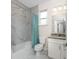 Bathroom with marble shower/tub combo, granite vanity, and window at 7186 Rosemont Dr, Englewood, FL 34224