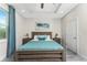 Spacious bedroom with wood bed frame and teal bedding at 7186 Rosemont Dr, Englewood, FL 34224