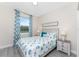 Bedroom with seashell bedding, nightstands, and beachy feel at 7186 Rosemont Dr, Englewood, FL 34224