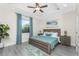 Spacious bedroom with wood bed frame and teal bedding at 7186 Rosemont Dr, Englewood, FL 34224